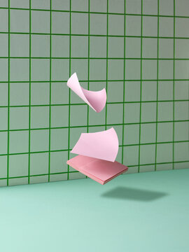 Floating Sticky Notes Against Geometric Patterned Green Wallpaper