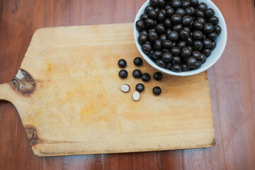Ball biscuit wafer with chocolate coating on white bowl in the wooden cutting board. sweet snack