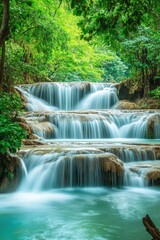 Obraz premium Majestic waterfalls cascading over rocky ledges amidst lush green forest