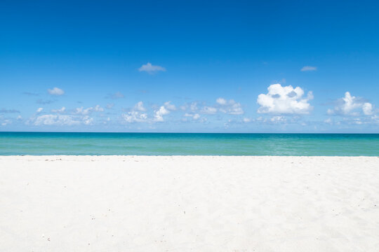 Miami beach turquoise water ocean, white sand and blue sky