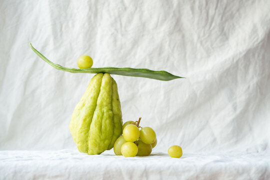 Balanced Still Life of Chayote, Green Beans, and Grapes

