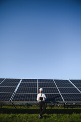 Solar panels. Engineer man on solar power station