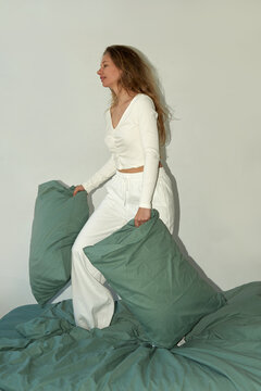 Woman holding two pillows