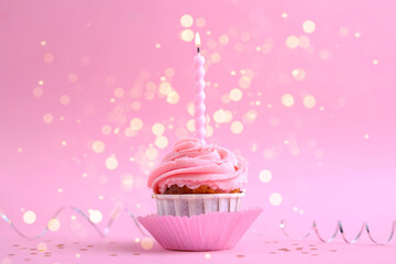 A delightful cupcake with a birthday candle in a colorful, cheerful festive setting