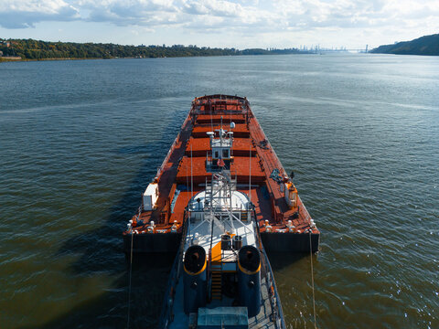 Rear View of Tugboat Towing Barge