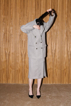 Unconventional Portrait With Grey Suit Against Wooden Wall