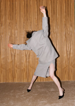Elegant Contemporary Dance Against Wooden Panel Background