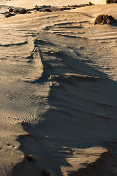Layered pattern in sand dunes and rocks