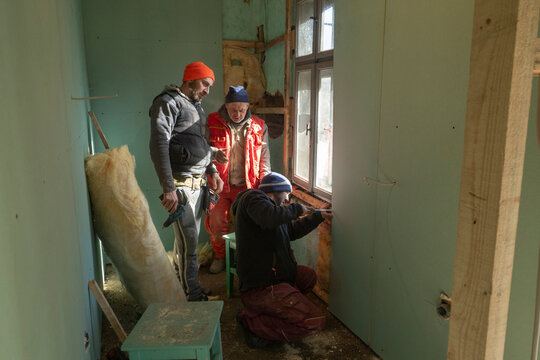 Tradesmen renovating bathroom