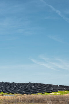 Large-scale solar panel installation in green rural landscape