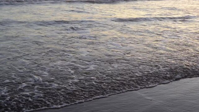 waves on the beach at sunset