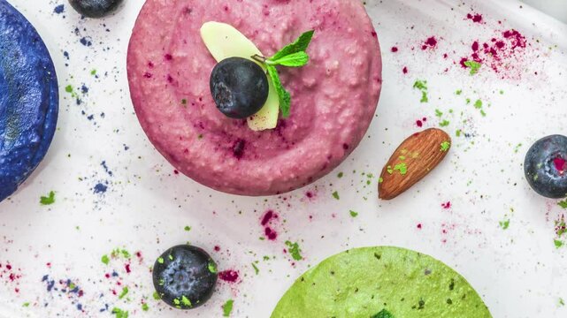 Healthy vegan cheesecakes. Assortment of colorful raw cashew cakes with matcha, acai, blueberry, mint and nuts. Gluten free diet food. Top view
