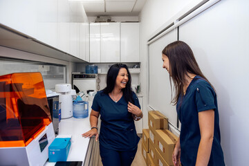 Health personnel sharing a light moment in a laboratory setting
