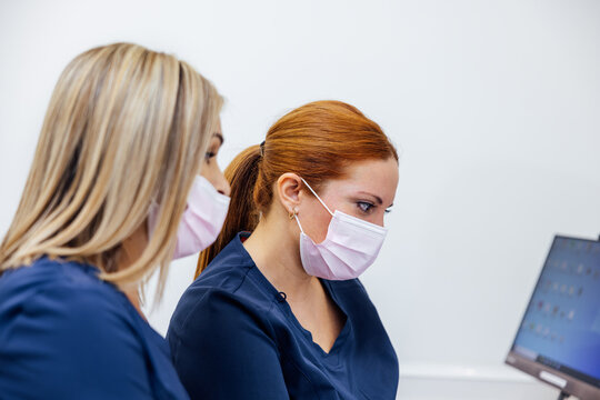 Healthcare professionals focused on computer tasks