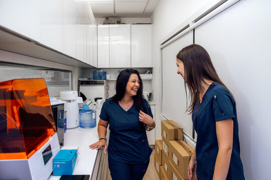 Health personnel sharing a light moment in a laboratory setting