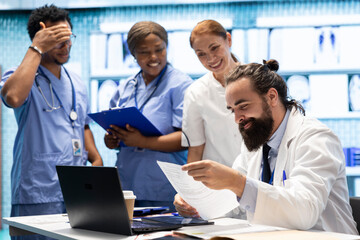 Joyful happy specialists finding suitable treatment plan for a diagnosis, competent healthcare...