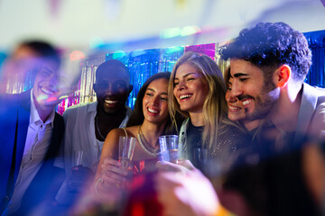 Friends enjoying a vibrant party with colorful lights