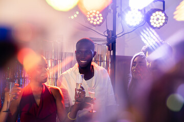 Joyful celebration with friends under vibrant party lights