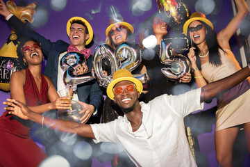 Excited Group Celebrating New Year 2025 in Festive Party Atmosphere