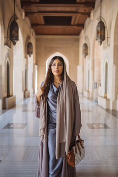 Omani woman walking in sultan qaboos grand mosque