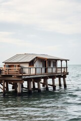 Charming Coastal House on Stilts Overlooking Serene Ocean Waters