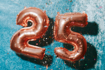 balloons forming number 25 and confetti, with motion blur
