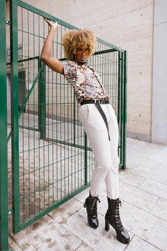 Stylish gay man expressing bold fashion in urban setting