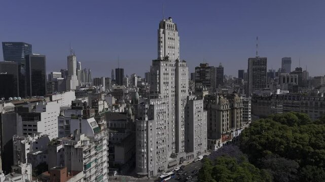 Drone slowly flies over plaza toward Edificio Kavanagh in Buenos Aires, Argentina