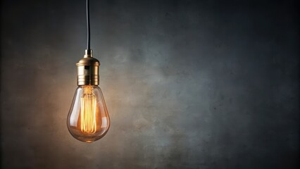 Vintage hanging light bulb over gray background, old school lighting