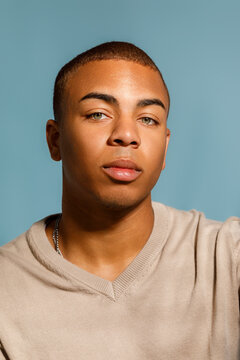 man poses against a  blue background