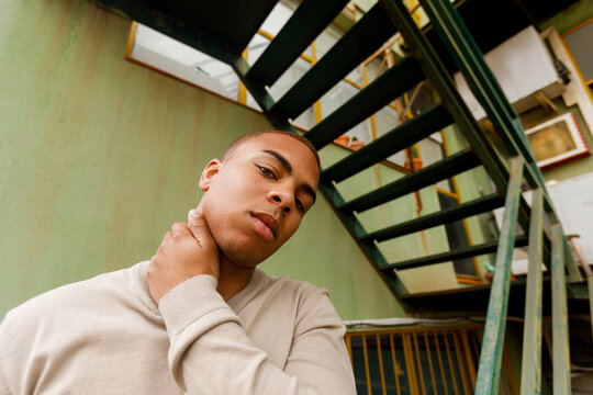 Young man poses thoughtfully 