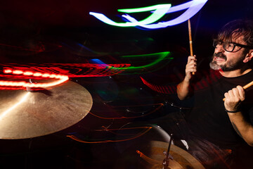 Dynamic drumming with vibrant light trails during live performance