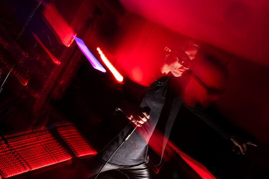 Energetic live concert performance with red lighting effects