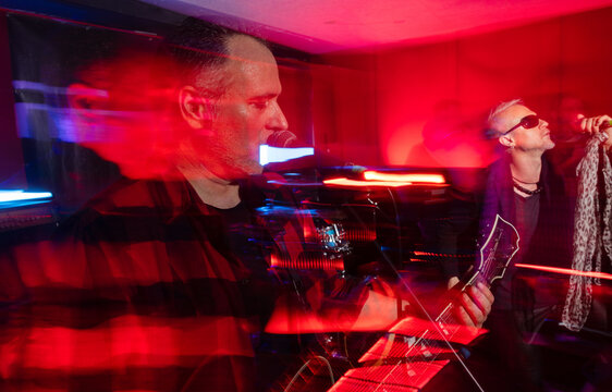 Dynamic live band performance with vibrant neon lighting