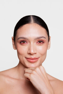 Confident Woman with elegant Makeup and Hand Under Chin