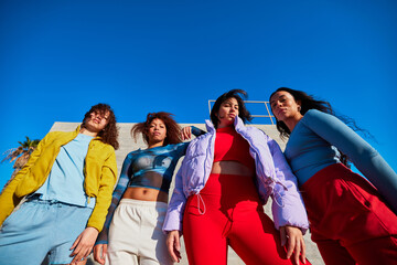 Cheerful women standing together in sunlight