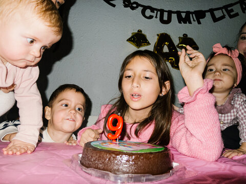 UGC Girl blowing out candles on her birthday
