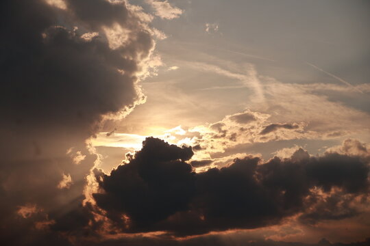 The sky is cloudy and the sun is setting