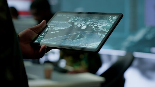 Military personnel in high tech environment safeguard classified information, monitor cybersecurity threats and digital warfare operations to protect against attacks and data breaches. Camera A.