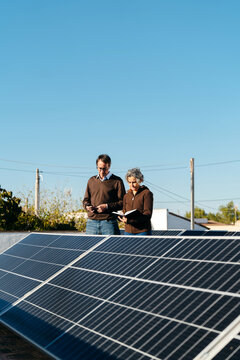 Homeowners inspecting their solar panels
