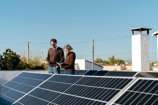 Homeowners inspecting their solar panels