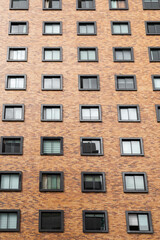 Beautiful brick residential building, with square windows, texture of the facade of a residential area, modern architecture and design in the city