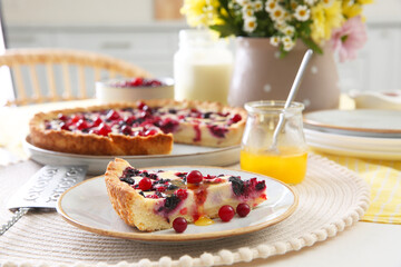 Piece of delicious currant pie with honey on white table indoors, closeup