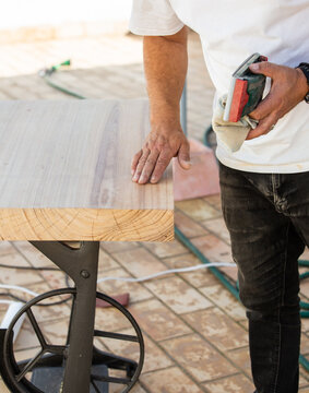 Carpenter hand finishing a piece of wood