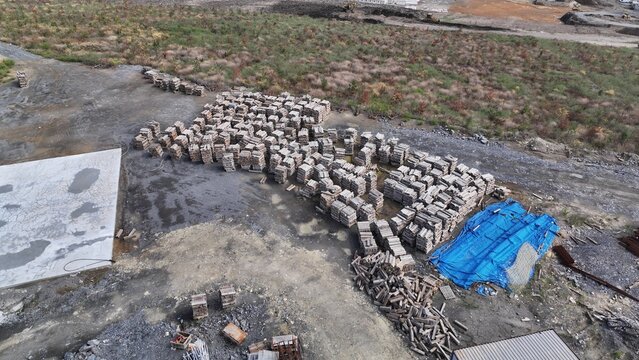dozens of tree stumps stacked on top of each other at the construction