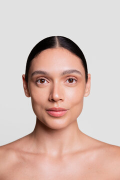 Front-Facing Portrait of a Young Woman with Radiant, Natural Skin