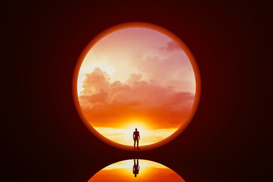 Silhouette of a man in a round window under a colorful sunset