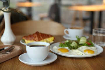 Delicious breakfast served on wooden table in cafe
