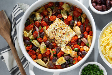 TikTok Baked Feta Pasta with roasted tomatoes, olives, feta cheese, herbs, artichoke hearts and rotini pasta