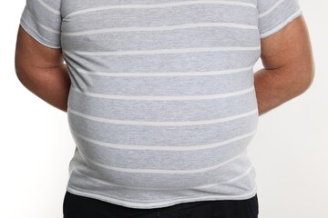 Overweight man in tight t-shirt on white background, closeup